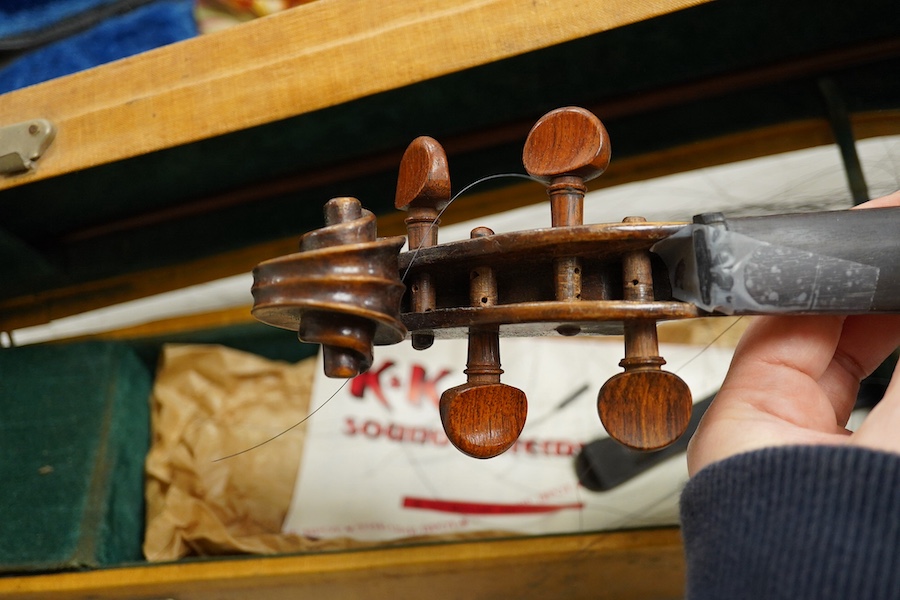 Four cased violins; an early 20th century violin, body 36cm, fitted with a microphone pick up taking a quarter inch jack plug, an early 20th century half size violin, body 32cm, and two student violins. Condition - poor